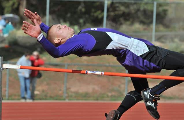 Senior Chris Oestmann leaps over the high jump bar in a meet April 11. Oestmann won four gold medals, one of which came in the high jump with his 6-foot, 7-inch leap at the Yavapai County Championships on April 27.