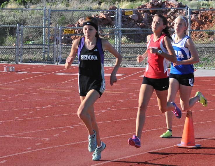 Mykala Seresun, left, is in the lead in the 1600-meter run during the Sedona Invitational at Sedona Red Rock High School, April 23. Seresun took first in all of her distance events at the Yavapai County Track and Field Championship meet, Friday, April 26, at Bradshaw Mountain High School and will be the one to beat at the state meet.